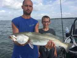 Two anglers at Aransas Pass fishing with one fish