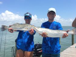 Two anglers fishing at Aransas Pass