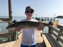 One fisherman casting a line in Aransas Pass