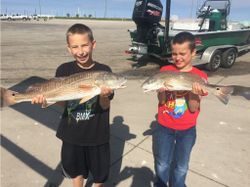 Two redfish, 25 inches each, caught in Aransas Pass