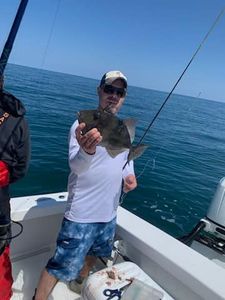 Angler with a 12-inch fish in Hatteras, North Carolina