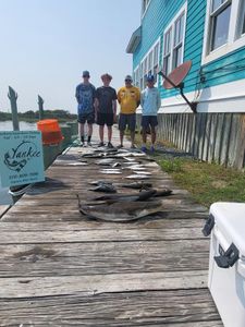 4 people fishing at Hatteras with a 57-inch catch