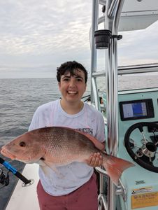 A pair of anglers with a big 23-inch fish caught while fishing in Hatteras