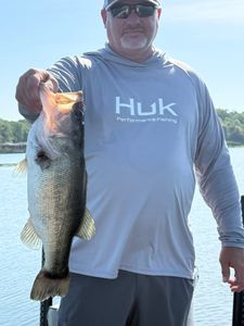 Angler holding large bass catch while fishing in Emory TX