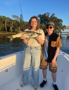 Snook fish caught by two people fishing at Jensen Beach