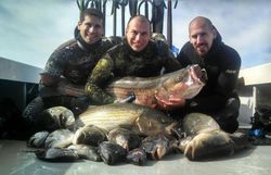 2 people fishing in Narragansett with 2 fish