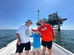 Three people enjoying fishing trip in Gulf Shores