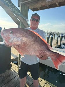 Large red snapper caught fishing in Gulf Shores AL displayed on marina dock