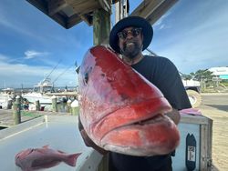 Large red snapper caught fishing in Gulf Shores AL displayed at marina dock