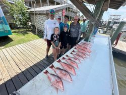 Red snapper fishing charter results displayed on dock cleaning table in Gulf Shores Alabama