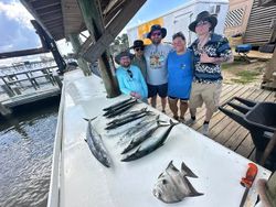 Fresh caught spadefish and king mackerel displayed on boat deck after Gulf Shores AL fishing trip