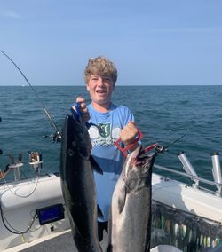 Man fishing in NY with 2 fish