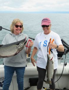 Two rainbow trout being caught while fishing in Oswego