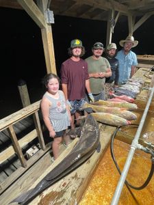Five people on a fishing cruise in Mississippi with a 20-inch fish
