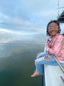 Person enjoying a cruise and fishing trip on the Mississippi River