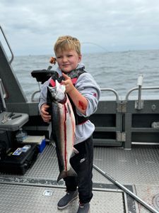 Trio of anglers posing with a large 130-inch fish in OR