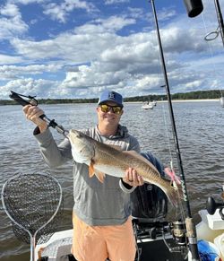 A person fishing for a redfish in North Myrtle Beach
