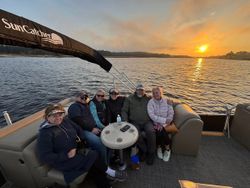Fishing boat at sunset in North Myrtle Beach SC with group enjoying evening charter