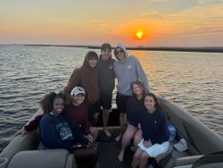 Group on fishing boat at sunset in North Myrtle Beach SC waters