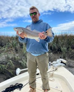 Angler holding a 14-inch redfish in SC