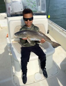 A fisherman with a large redfish caught in Charleston, South Carolina