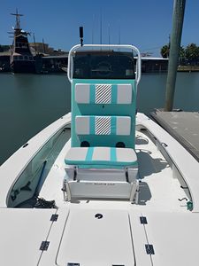 Fishing boat with turquoise captain's chair on deck at Port Aransas TX marina