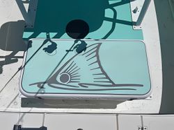 Fishing boat deck with painted triangular logo featuring radiating sun design in Port Aransas TX