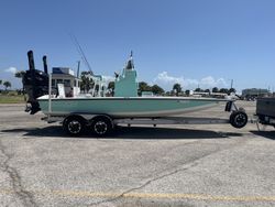 Green fishing boat with outboard motor on trailer at Port Aransas TX marina