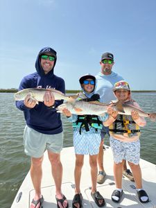 Successful redfish fishing trip in Port Aransas TX with multiple caught fish displayed on boat