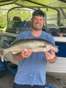 Angler holding a 25-inch walleye fish in NY