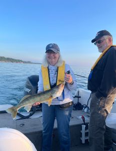Angler proudly holding a large walleye fish caught in New York