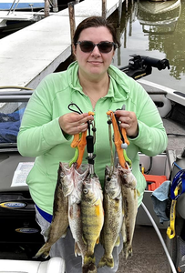 Three fishing poles with a person in the background in New York