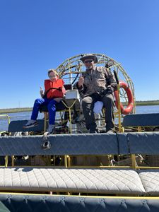 Airboat tour on water in Orange TX with large fan and protective cage