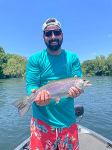 Angler catching a beautiful rainbow trout in Branson