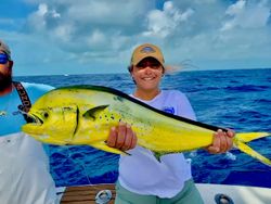 A lone angler fishing in the picturesque Islamorada, holding a 28-inch catch