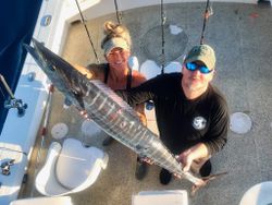 Two anglers posing with a big fish in Islamorada
