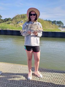 A person holds a 16-inch sheepshead fish in Gulf Shores