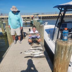 Two people fishing in the waters of Gulf Shores