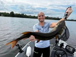 A person fishing in ON with a 40-inch fish