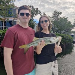 Two people fishing with a single 17-inch fish in FL