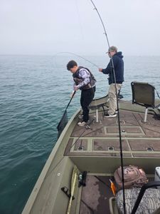 Fishing from boat deck on calm waters in Elma New York
