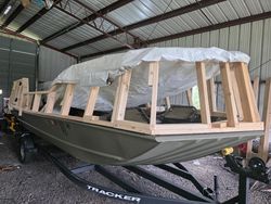 Jon boat under construction with wooden frame and tarp cover in metal building workshop in Elma New York
