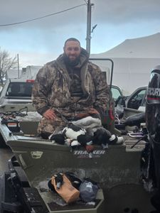 Hunter with harvested waterfowl on boat in Elma New York