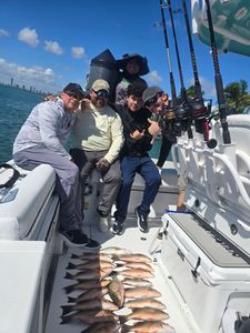 Five people fishing in Florida on cruises and fishing trips