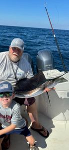 A fisherman with an Atlantic Sailfish on their line in FL