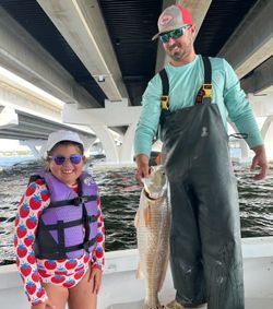 Helped this girl reel in her first Redfish Trophy!