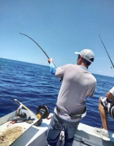 Deep sea fishing with bent rod showing active catch off Port Canaveral FL