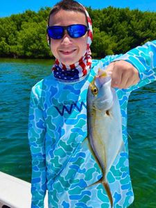 A Crevalle Jack fish caught by two people fishing in Miami