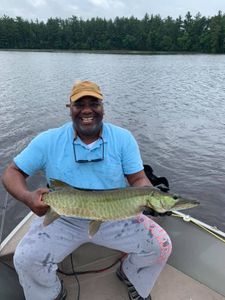 A fisherman holding a mighty muskellunge in Wisconsin Rapids