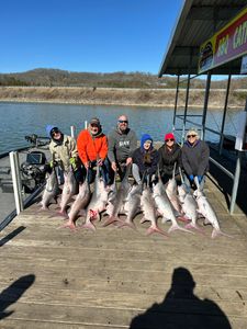 6 people fishing with 2 big fish in Branson